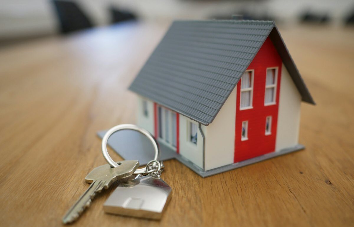 House keys next to a small model house